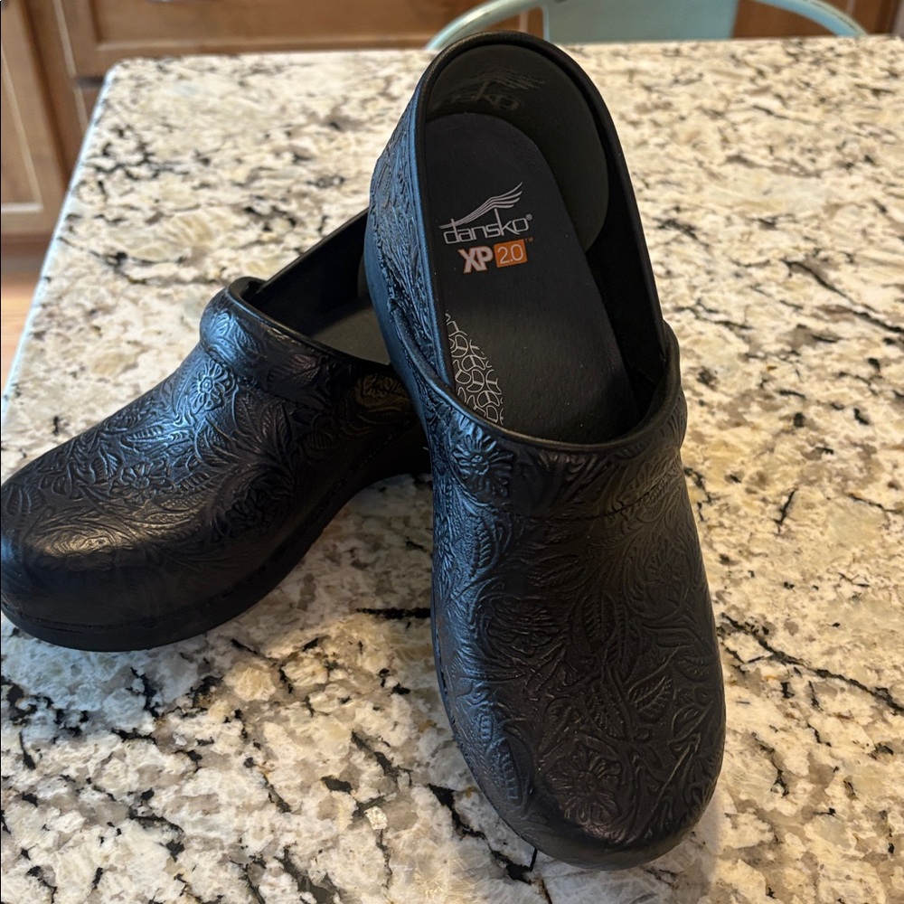 Dansko Black Floral Embossed Clogs